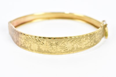 Lot 296 - A yellow metal hinged snap bangle, with bright...