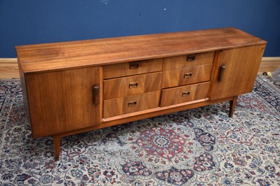 Lot 1152 - A mid century teak sideboard with an...