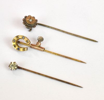Lot 1258 - Three yellow metal stick pins contained within...