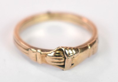 Lot 1262 - A yellow metal ring modelled as two hands...