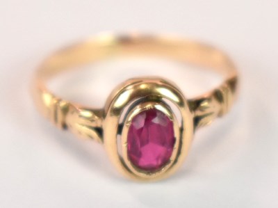 Lot 1263 - A yellow metal ring set with oval pink stone,...