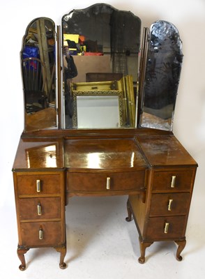 Lot 1579 - An Art Deco burr walnut veneered mirrored back...