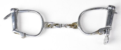 Lot 576 - A pair of vintage chrome plated handcuffs...