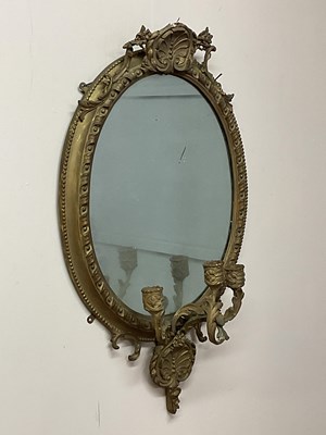 Lot 716 - An oval gilt gesso mirror with decorative...