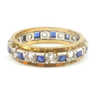 Lot 717 - A 9ct gold eternity ring, the central band set...