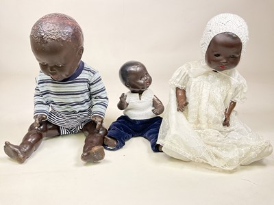 Lot 340 - Three black baby dolls, comprising a 40cm...