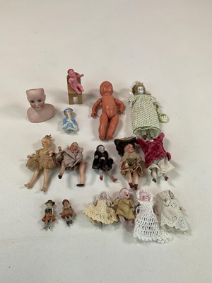 Lot 347 - A collection of miniature dolls including a...
