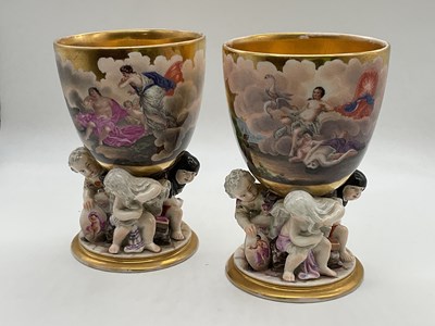 Lot 460 - KPM; a pair of porcelain beakers, each with...