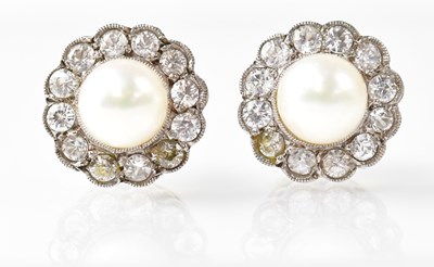 Lot 1015 - A pair of stud earrings set with pearls in a...