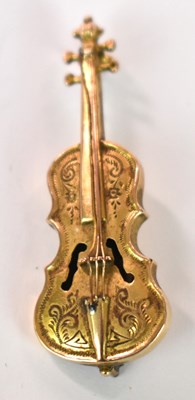 Lot 1236 - A 9ct yellow gold brooch modelled as a cello,...