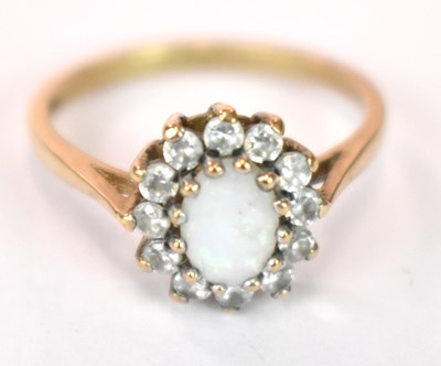Lot 1238 - A 9ct yellow gold opal set flowerhead ring,...