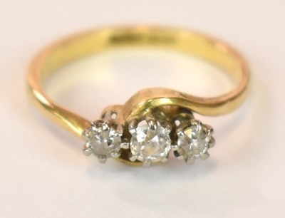 Lot 1243 - An 18ct yellow gold platinum tipped three...