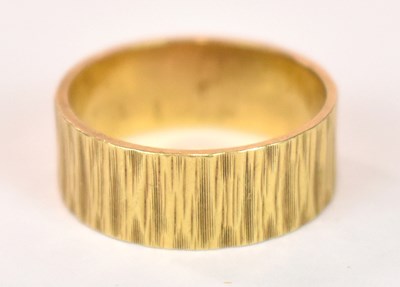Lot 1245 - An 18ct yellow gold wedding band engraved with...