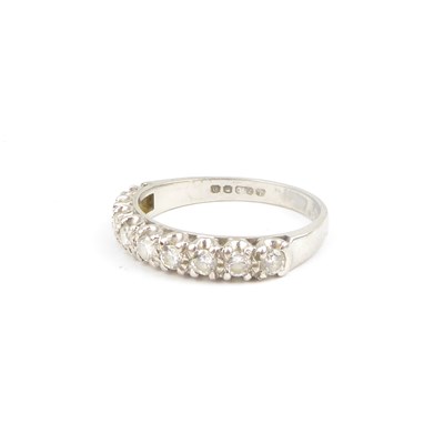 Lot 707 - An 18ct white gold half eternity ring set with...