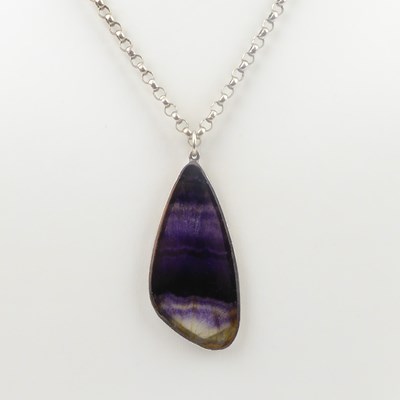 Lot 800 - A silver mounted polished Blue John pendant,...