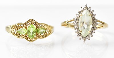 Lot 720 - A 9ct gold three-stone peridot ring with...