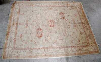 Lot 1438 - A large rug with stylised floral decoration on...