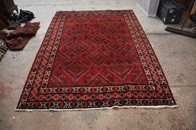 Lot 1206 - A modern red ground rug with central geometric...
