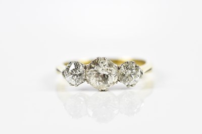 Lot 45 - An 18ct yellow gold three stone diamond ring,...