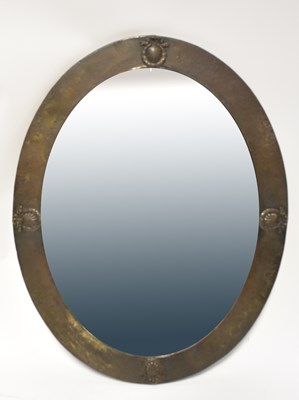 Lot 57 - An Arts and Crafts pewter oval framed bevel...