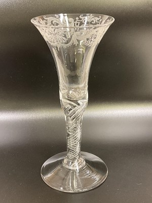 Lot 520 - An English engraved air twist wine glass,...