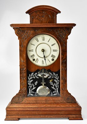 Lot 75 - An American walnut cased mantel clock, the...
