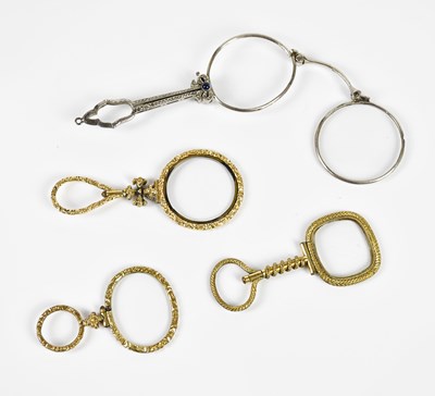 Lot 1383 - Three 19th century gilt metal quizzing glasses,...