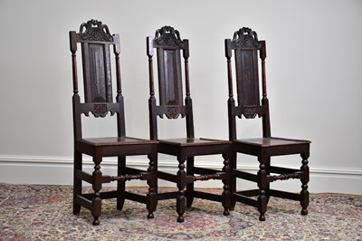 Lot 1172 - Three 18th century carved oak hall chairs,...