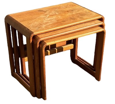 Lot 65 - A mid century teak nest of three graduated...