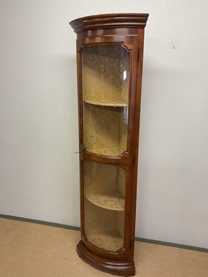 Lot 705 - A reproduction tall bowfronted corner cupboard,...