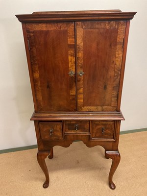 Lot 678 - A reproduction raised mahogany cabinet on four...