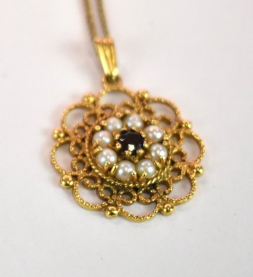 Lot 1148 - A 9ct yellow gold pierced garnet and pearl set...
