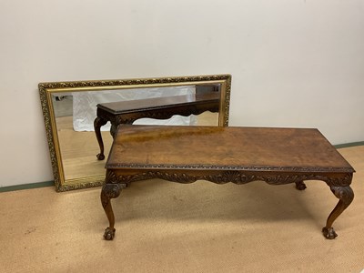Lot 722 - A walnut coffee table raised on ball and claw...