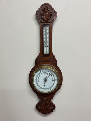 Lot 429 - A carved oak barometer with porcelain dial and...