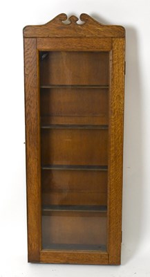 Lot 1558 - A carved oak collectors’ wall hanging cabinet,...