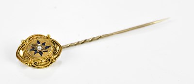 Lot 23 - A yellow metal pin, set with a central pearl.