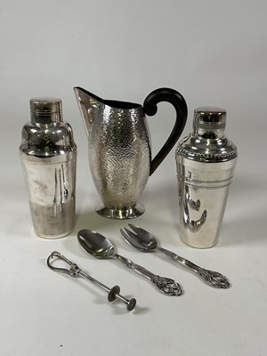 Lot 1005 - Two silver plated cocktail shakers, a stylish...