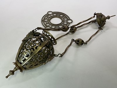 Lot 539 - A brass pendant light with pierced sections...