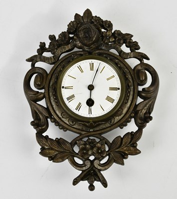 Lot 1521 - A cast metal wall clock with white enamel dial...
