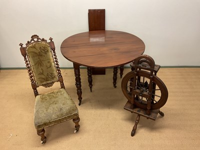 Lot 657 - A walnut drop-leaf table, height 70cm,...