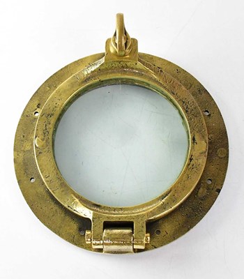 Lot 671 - An early 20th century brass porthole and cover,...