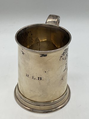 Lot 1077 - A George V hallmarked silver mug, engraved...