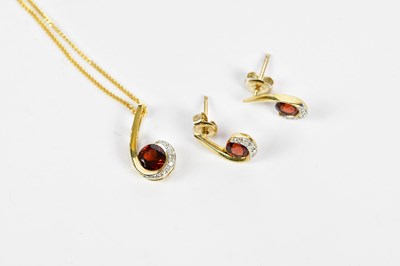 Lot 386 - A 9ct yellow gold garnet and diamond chip...