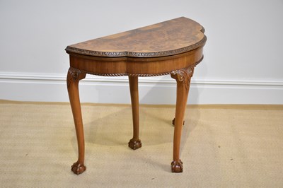 Lot 1033 - A 1930s walnut demi-lune serpentine fronted...