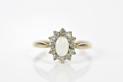 Lot 200 - A 9ct yellow gold opal and diamond dress ring,...