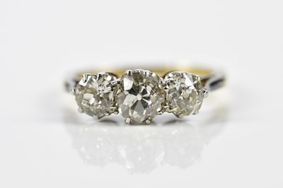 Lot 67 - A yellow and white metal graduated three stone...
