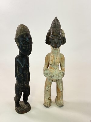Lot 518 - Two carved wooden African figures, height 51cm.