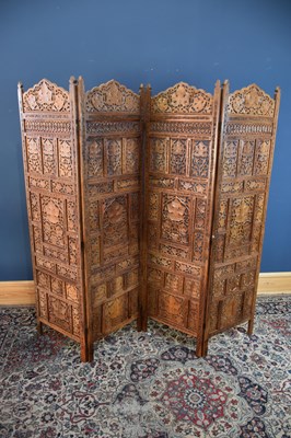 Lot 1015 - An Eastern carved hardwood four division...