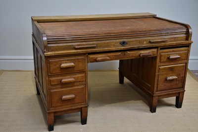 Lot 1028 - An early 20th century roll-top knee-hole desk...