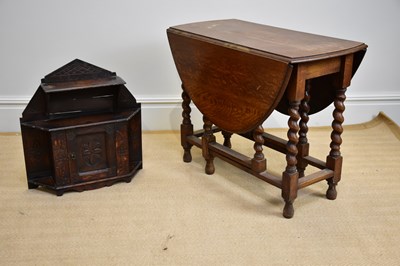 Lot 1057 - A 1920s oak drop-leaf gateleg dining table,...